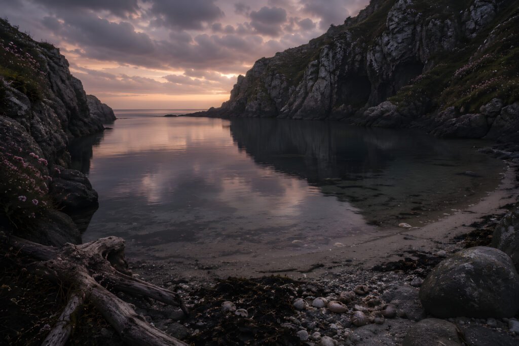 Hidden cove with still water and stone cliffs in When the Tide Forgot to Turn